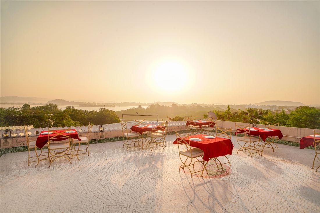 Rooftop dining table laid for sunset over Fateh Sagar at Vikram Garh Lakeview