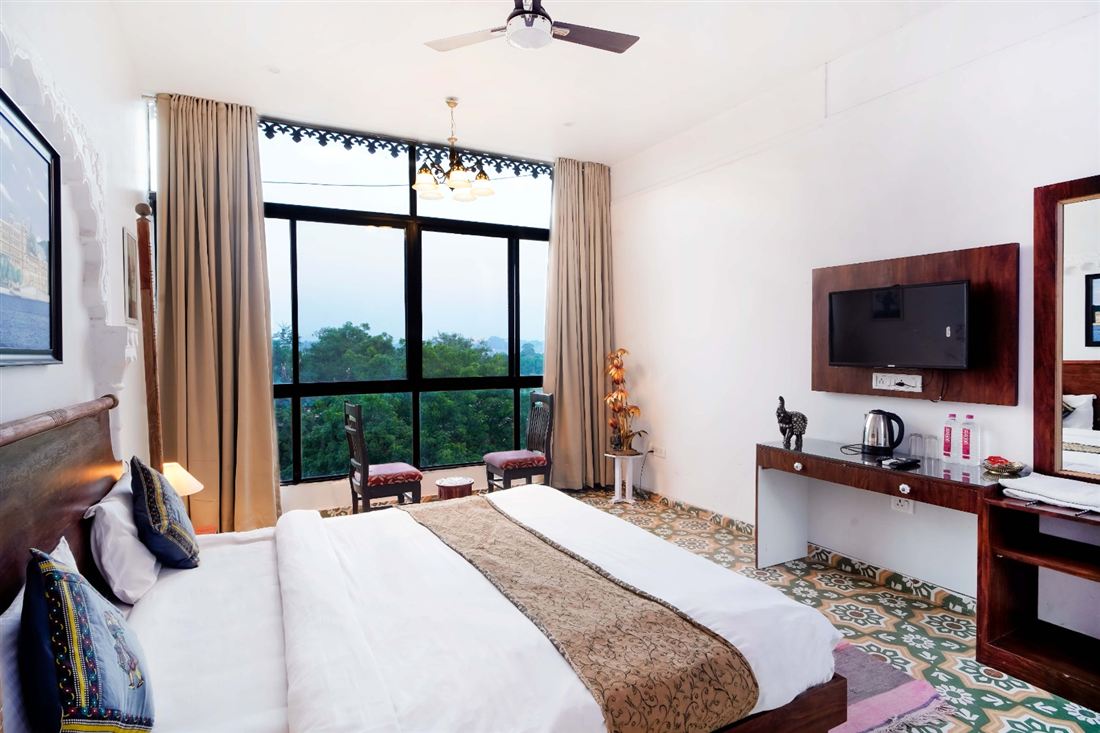 Guest room window framing Fateh Sagar and the hills