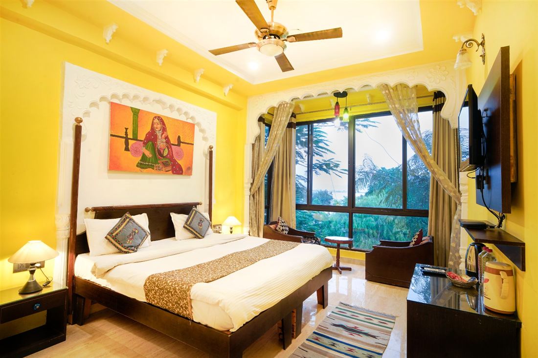Bright, warmly furnished guest room at Vikram Garh Lakeview