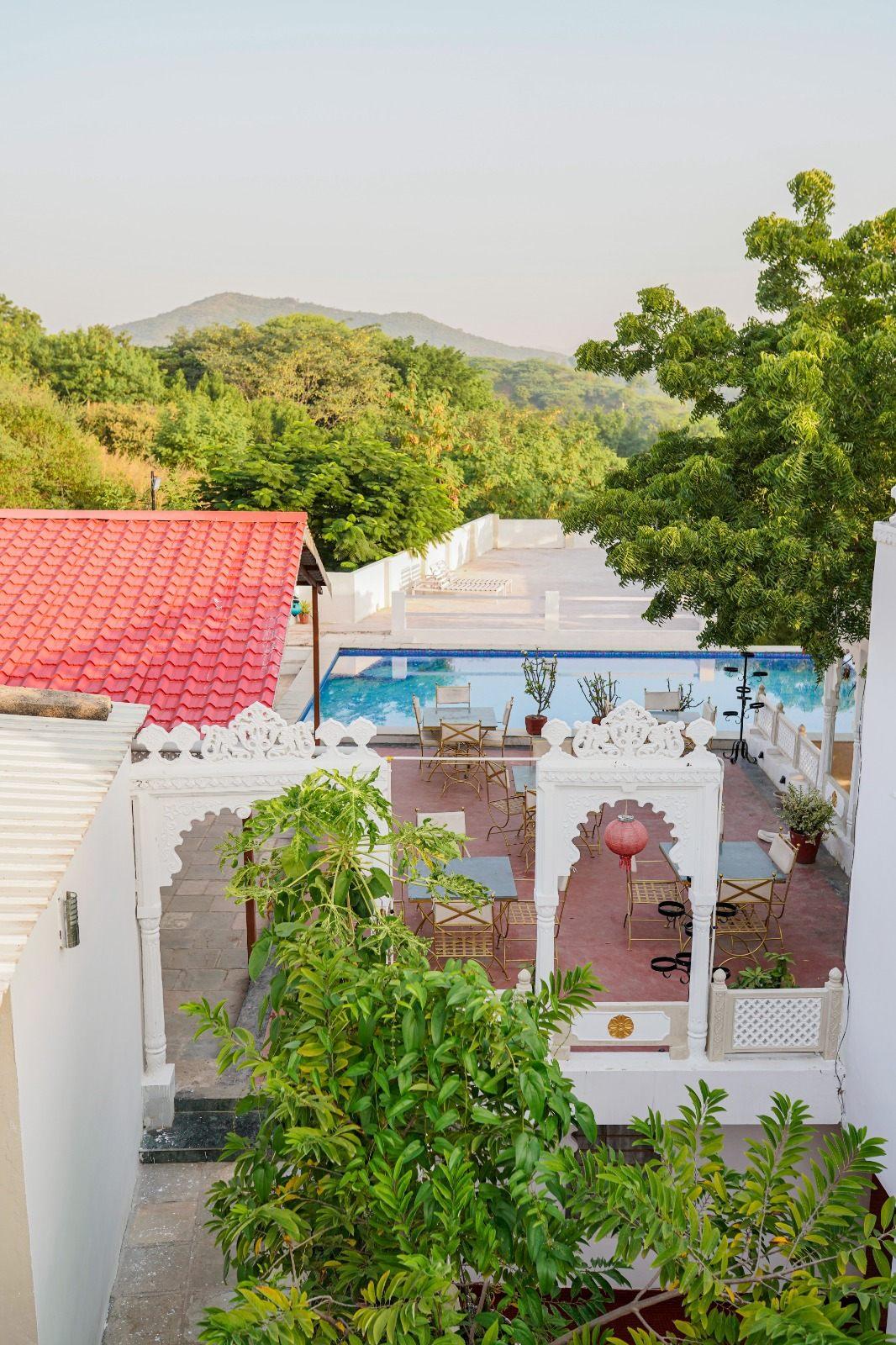 Vikram Garh Lakeview seen from above, with the pool and terrace on the hill over Fateh Sagar, Udaipur